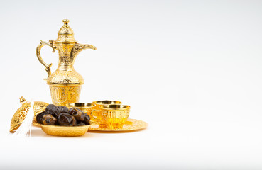 Fototapeta na wymiar Ramadan kareem with premium dates, lantern and arabic coffee mug on white background. Selective focus, copy space and Ramadan Kareem concept