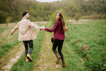 Obraz premium Happy couple walking on the nature at the mountains