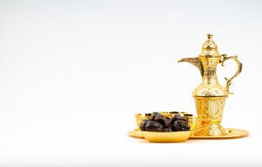 Premium dates and arabic coffee set on white background. Selective focus, copy space and Ramadan Kareem concept