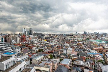 Shinjuku, Tokyo dark gloomy hdr cityscape with view apartment buildings residential area on cloudy, grey stormy and overcast day with many houses