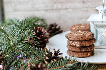 Christmas decorations - oat biscuits for Santa Claus and branches of coniferous trees