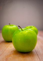 green apples with a gray background