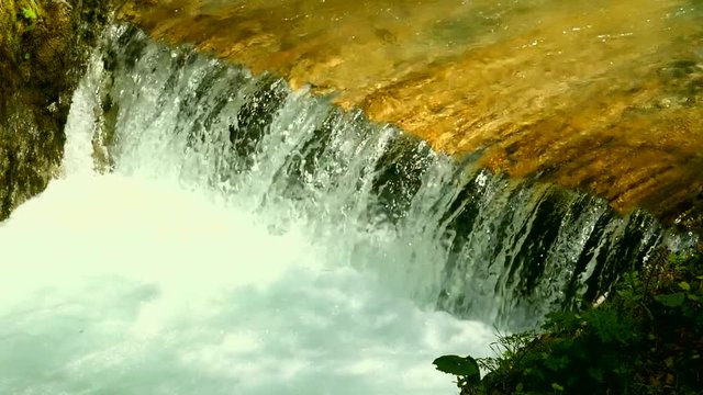 Mini waterfall on the mountain river , slow motion