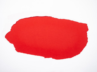 Torn white paper isolated on red