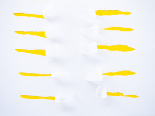 Torn white paper isolated on yellow