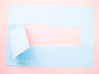 Torn pastel pastel blue paper isolated on pastel pink