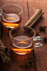 Herbal Tea with Star Anise and Cinnamon in a Cup on Wooden Table