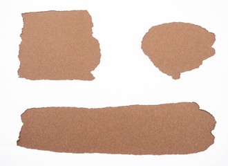 Torn white paper isolated on brown