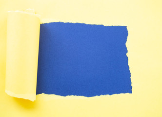 Torn yellow paper isolated on blue