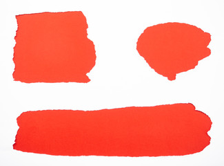 Torn white paper isolated on red