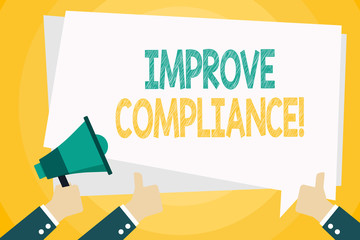 Text sign showing Improve Compliance. Business photo text action or fact of complying with a wish or comanalysisd Hand Holding Megaphone and Other Two Gesturing Thumbs Up with Text Balloon