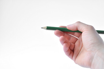 green pencil in hand on white background