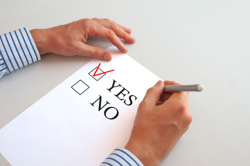 questionnaire Yes and no, word Yes with red check mark, pen in hand
