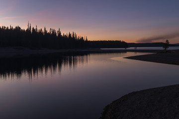 A stunning sunset on a lake in Yellowstone National Park, reflections of colours in the lakes waters