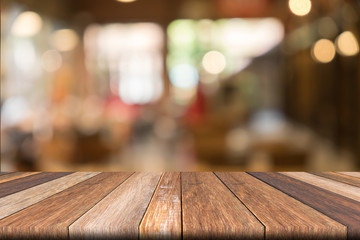 Empty wooden table of brwon in front Warm orange color of bokeh on wooden background