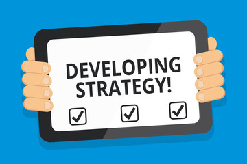 Word writing text Developing Strategy. Business photo showcasing Game plan that sets specific goals and objectives Color Tablet Smartphone with Blank Screen Handheld from the Back of Gadget