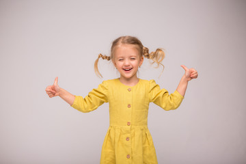 girl blonde green linen dress white background.girl the blonde smiles.the concept of summer and natural fabrics. space for text