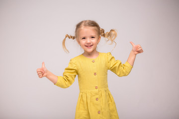 girl blonde green linen dress white background.girl the blonde smiles.the concept of summer and natural fabrics. space for text