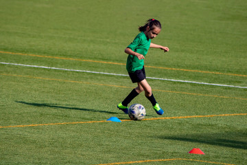 Little girl in a soccer training