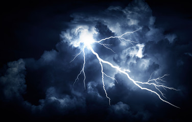 Naklejka na ściany i meble Lightning strike on the cloudy dark sky.
