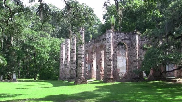 The Pillars of Old Sheldon Church Ruins in Beaufort County, North Carolina with Green Grass and Trees