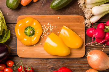 Sweet yellow pepper and other fresh vegetables and ingredients for cooking