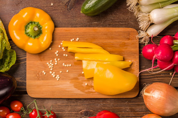 Sweet yellow pepper and other fresh vegetables and ingredients for cooking