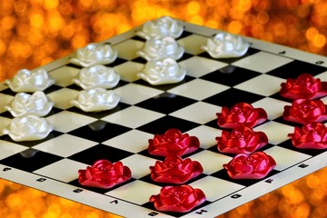 Checkers of roses on a checkered Board, the competition on a festive sparkling background. Checkers is a popular ancient Board logic antagonistic game, on a cell Board for two intelligent rivals.