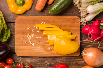 Sweet yellow pepper and other fresh vegetables and ingredients for cooking