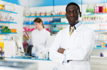 Naklejka na ściany i meble African American pharmacist in drugstore