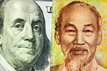 Portrait of President Franklin on banknote 100 US dollars and  portrait of Ho Chi Minh for 10,000 Vietnamese dong. Concept of  currency exchange rate, the stock exchange, internet trading,