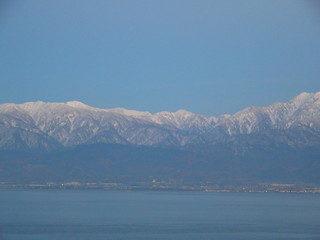 sea, mountains beyond sea, sunlit tops of mountains