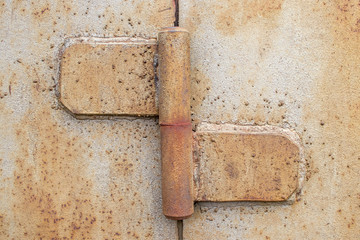 metal hinge on the gate with rust