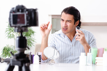 Young handsome man recording his blog in hygiene concept 