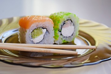 Delicious mouth-watering rolls on a glass plate.Sushi.