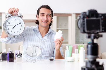 Young handsome man recording his blog in hygiene concept 