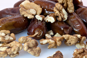 Walnut and date on the white background