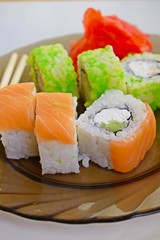Delicious mouth-watering rolls on a glass plate.Sushi.