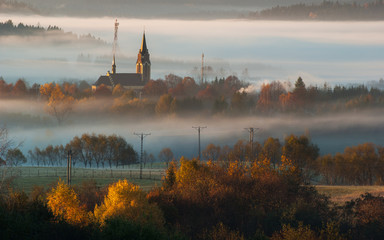 Church in the mountains. Autumn morning in the mist.