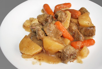Plate of delicious homemade beef stew.  With beef, carrots and potatoes