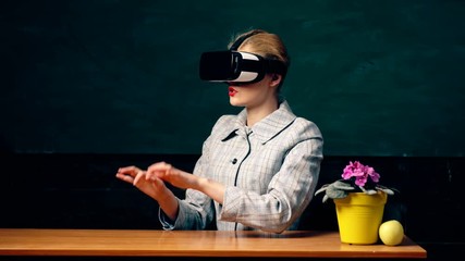Augmented reality. Woman in VR glasses. Confident woman in virtual reality headset pointing in air. Modern education. Back to school. Virtual education. Virtual reality gadget. Virtual cyber space. - Powered by Adobe
