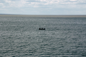 Fishermen in the sea on a small boat
