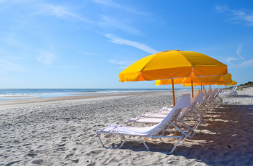 Beach Chairs Umbrellas Lounge on the Ocean Surf and Beach Sand