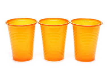 Orange plastic cups isolated on white background