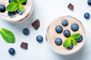 Greek yogurt vanilla chocolate panna cotta with mint leaves and fresh blueberries