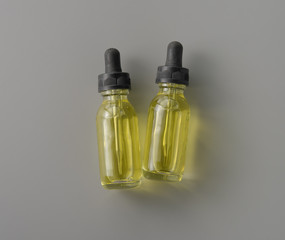 Bottle of essential oil on grey background for print design and mock up