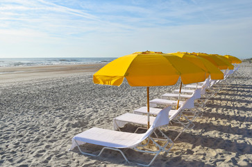 Beach Chairs Umbrellas Lounge on the Ocean Surf and Beach Sand