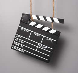 Clapper for movie Photo taken hanging on ropes,gray background