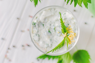 Exotic salad with nettles and eggs in a glass lined in layers.