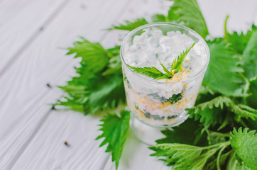 Exotic salad with nettles and eggs in a glass lined in layers.